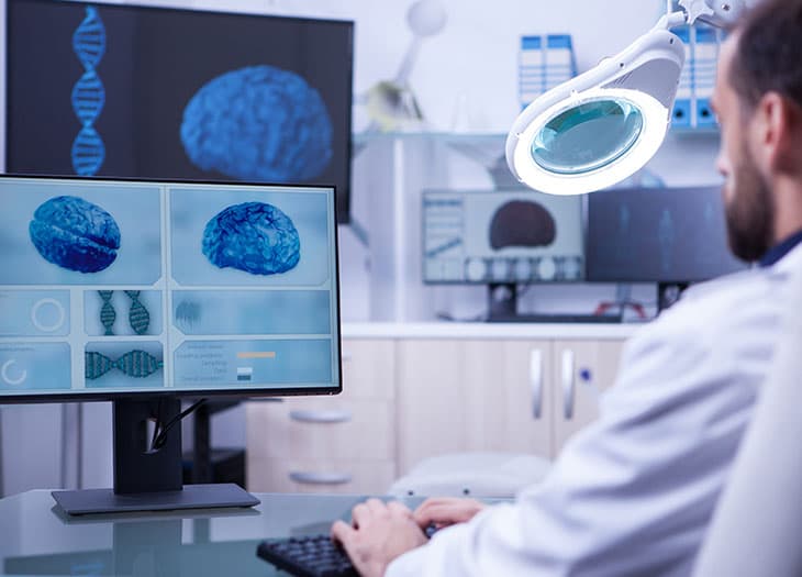 Researcher sitting at a computer.