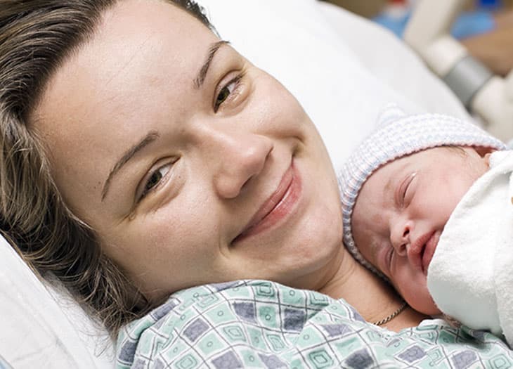 Young woman with her newborn baby.