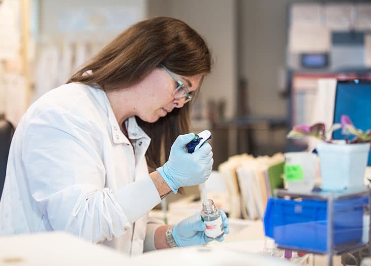 Immunology Reference Lab technican working with a sample.